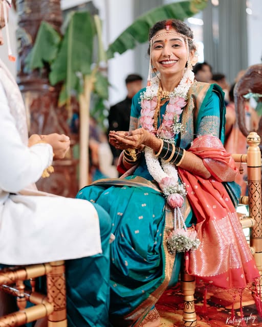 Smiling bride in a teal sari during a traditional wedding ceremony, from Pooja Salunkhe Makeover's portfolio
